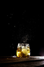 Vertical Shot Of A Refreshing Drink With A Splash Over Black Background