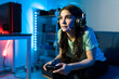 Woman using headphones and a microphone for a videogame