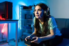 Woman Using Headphones And A Microphone For A Videogame