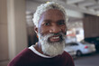 © Wavebreak Media - Portrait of casually dressed african american senior man with beard smiling in street