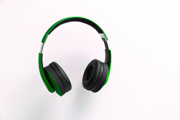 Green headphone isolate on white background.