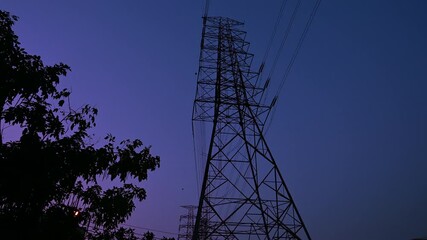 Wall Mural - Electricity concept, Close up high voltage power lines station. High voltage electric transmission pylon silhouetted tower.