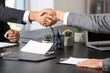 © Pixel-Shot - Businessmen shaking hands in office