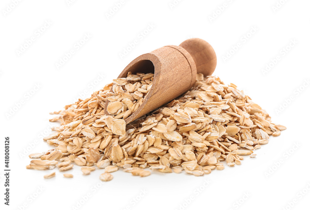 Scoop with raw oatmeal on white background