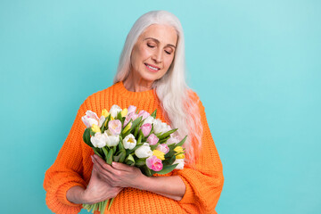 Sticker - Photo of charming peaceful old lady hold look tulip flowers bouquet isolated on pastel teal color background