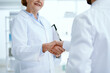 © yurolaitsalbert - close-up. people in white coats shaking hands.