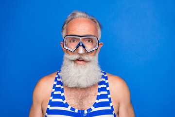 Sticker - Photo of handsome happy positive smiling old man in goggles wear swimming suit isolated on blue color background