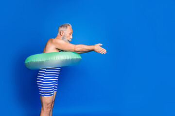 Sticker - Profile photo of optimistic grey beard man jump wear lifebuoy blue swimsuit isolated on blue background