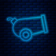 Poster - Glowing neon line Cannon icon isolated on brick wall background. Vector.