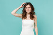 © ViDi Studio - Puzzled confused pensive worried bride young woman 20s in beautiful white wedding dress put hand on head isolated on blue turquoise wall background studio portrait. Ceremony celebration party concept.