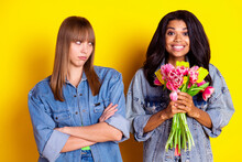 Portrait Of Positive Displeased Ladies Folded Hands Look Dark Skin Fellow Isolated On Yellow Color Background