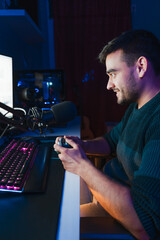 Young gamer playing video games online while broadcasting on social media - Working live streaming on internet platforms