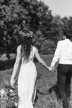 Groom And Bride Backs. Black And White Photography. Summer Wedding. Bouquet
