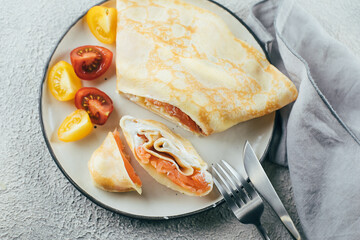 Wall Mural - Crepes with stuffed cream cheese and salmon. Lunch meal food concept. Top view