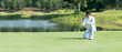 © freebird7977 - Golfer man playing golf aiming shot for putting ball on the hole with club on green course.  Professional people hobby in holiday and vacations in กay on club golf.  copy space for banner