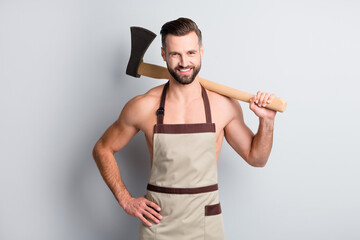 Sticker - Portrait of attractive cheerful guy butcher wear apron carrying wooden ax on shoulder isolated over light grey color background