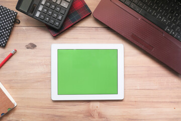 Flat composition of digital tablet and office stationary on black background 