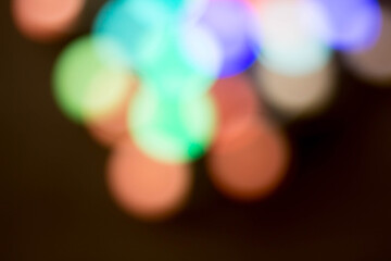 blurred multicolored lights on a dark background.