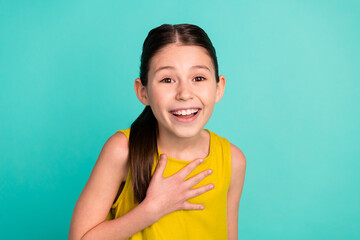 Photo of optimistic nice brown hair girl wear yellow dress isolated on bright teal color background