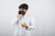 © rastockinc - Serious conversation on the phone. Curly haired young doc talking with phone