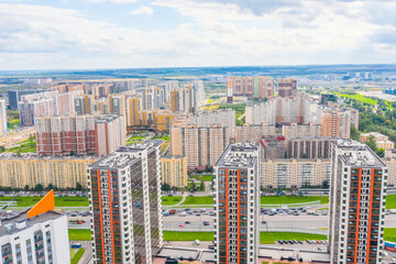 Wall Mural - Panoramic aerial view of the city with multi-storey residential buildings and highways.