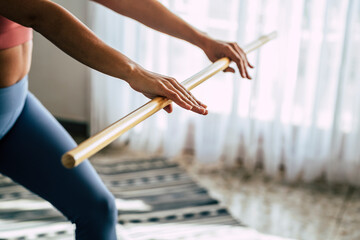 Close up of woman hands doing pilates and gym sport exercises at home for healthy care lifestyle - wellbeing people goals and successful lifestyle