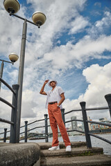 low angle view of male fashion model posing in city