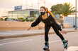 © Alberto Case - Caucasian girl with mask skating on roller skates on the promenade of Palma de Mallorca at a beautiful sunset, Spain (Perfect for copyspace)