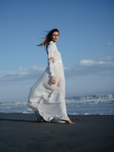 Woman In White Dress Near The Ocean Barefoot Portrait In Full Growth