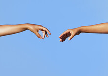 Two Women's Arms Outstretched Reaching Toward Each Other