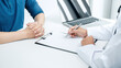 © Ngampol - Doctor and patient are discussing something in medical clinic