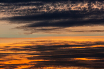 Wall Mural - Photo of cloudy sky at sunset with orange reddish sky
