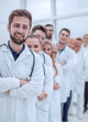 © ASDF - close up. confident male doctor standing in front of his colleagues.