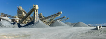 Quarry Machines And Piles Of Gravel Over Blue Sky. Stone Crushing And Screening Plant, Panoramic View