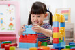 © M-image - young girl playing creative toy blocks for homeschooling
