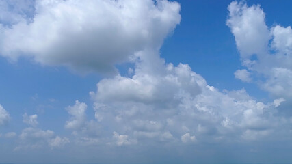 Wall Mural - Blue Sky with White Fluffy Clouds as a Back Ground