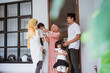 © Odua Images - excited asian muslim family visiting friend during eid fitri mubarak at home