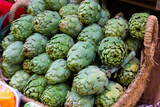Fototapeta Kuchnia - Pile of fresh young buds of artichokes on showcase of greengrocery