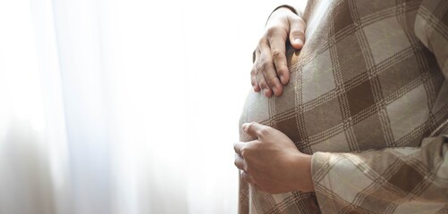 Wall Mural - Close up of a pregnant belly., motherhood Concern for the unborn child.