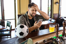 Sad Young Man After Losing Of His Sports Bet In Pub