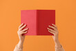 © Pixel-Shot - Woman with blank book on color background