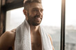 Happy male athlete with towel
