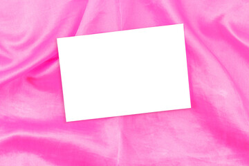 Wall Mural - Mockup of white business cards on soft pink fabric, copy space