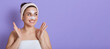 © sementsova321 - Cheerful lady posing isolated over lilac background with white skin stickers on nose and forehead, cleansing procedure, happy female looking aside, copy space for ad, spreads hand like wants clapping.