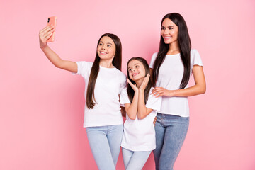 Sticker - Photo portrait mommy with two daughters taking selfie smiling in casual clothes isolated pastel pink color background