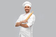 © Syda Productions - cooking, culinary and people concept - happy smiling male chef or baker in toque with rolling pin over grey background