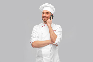 Sticker - cooking, culinary and people concept - happy smiling male chef in toque and jacket calling on smartphone over grey background