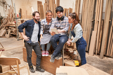 Group of craftsmen at the tablet computer