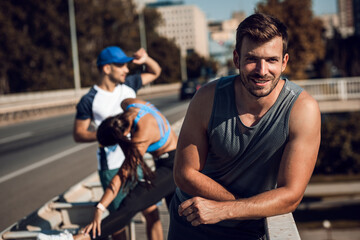 Wall Mural - Portrait of man in sports clothing standing and looking at camera.