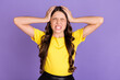© deagreez - Portrait of nice stressed brunette hairdo girl cover head wear yellow t-shirt isolated on vivid lilac color background
